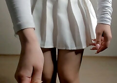 Blonde yogi stretches in white crop top and skirt with no underwear beneath