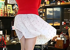Confident maid asserts control in a home office with her legs and gaze
