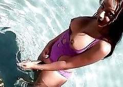 Gorgeous shemale cutie in bathing suit gets her cock sucked