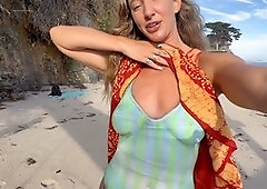 Steph In Space shows off her bodypaint swimsuit in a public display at the beach