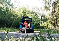 A pretty day to clean car windows on a path on the side of a forest road. My minidress shows off my ass-plug bells.