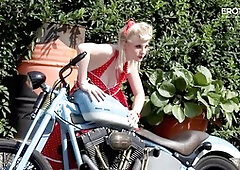 German blonde camgirl Casey Deluxe showcases her big natural tits on a motorcycle for EroticOnly!