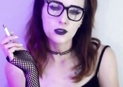 Darksome gothic beauty smokes whilst wearing fishnet nylons. This babe takes slow, seductive drags with her ebony lipstick and fishnets on full displa