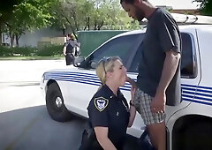 Black dude fucks two white cops by the police car