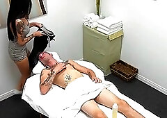 Dark haired girl is giving a nice, erotic massage to her client, on the massage table