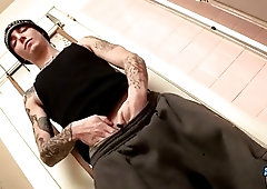 Slim gay with sexy tattoos tugs on his hard cock
