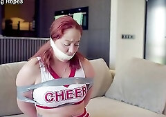 Cute Youthful red head fastened and gagged by her intruder as cheer leader EP