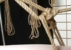 Bound submissive Asian teen wiggles as her pussy is toyed