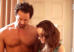 An artist gets a live painting session from a hung model