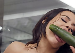 While getting her ass pierced, the babe is using cucumber on her pussy