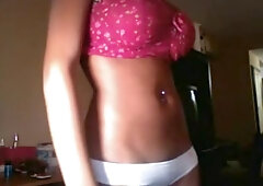 Chocolate-skinned boomshell in pink bra demonstrating her details