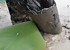 Two Thai men in high boots swim in the mud!