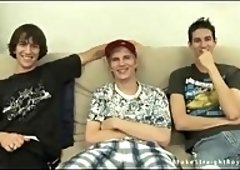 Three Twinks Relaxing On A Couch