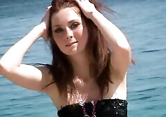 Katie Gold is a vibrant, freckled teen beauty who embodies the essence of summer at the beach. Her sun-kissed skin is dotted with playful freckles, a 
