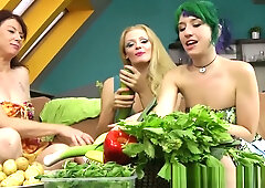 Three women explore each other with fresh vegetables in a sensual indoor session
