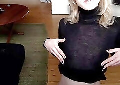 Kate may in a black dress on the floor with a toy