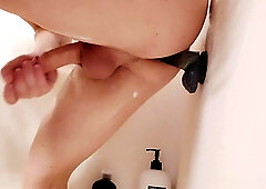 Femboy plays with fake penis in the douche