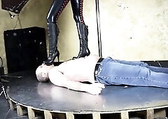 Latex femdom babe walking on slaves body.