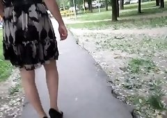 Crossdresser in stockings goes out for a walk with camera