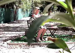 British mature BBW Aunt Judy with big natural tits pleasures herself slowly in the garden at dusk while someone watches from the trees