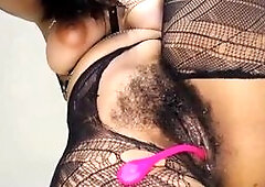 Chubby brunette babe with big tits and hairy pussy wearing ripped fishnet stockings masturbates with dildo closeup on webcam POV